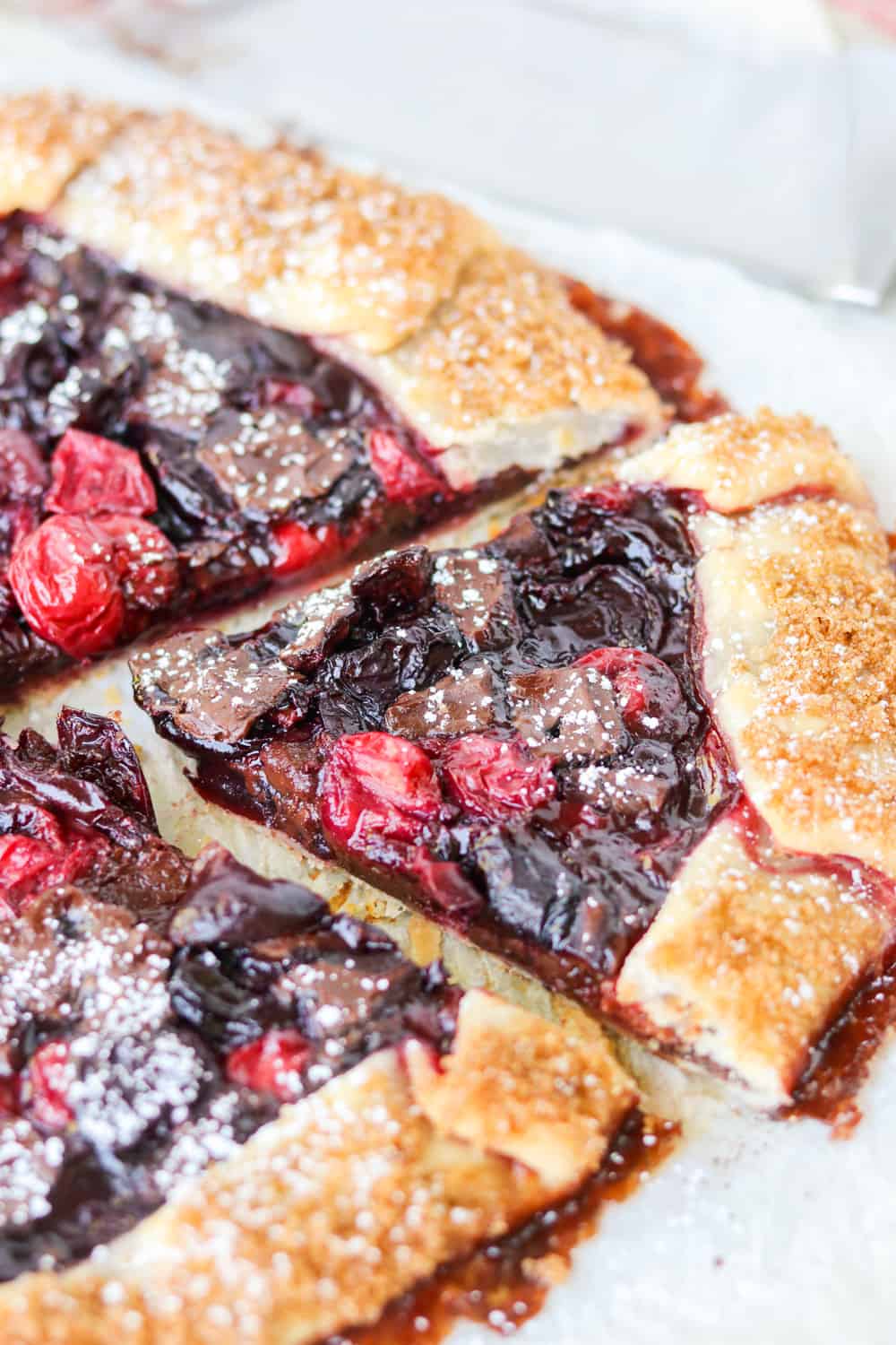 A slice of a Cherry and Dark Chocolate Galette.