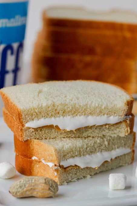 A sandwich made of peanut butter, marshmallow fluff and bread.