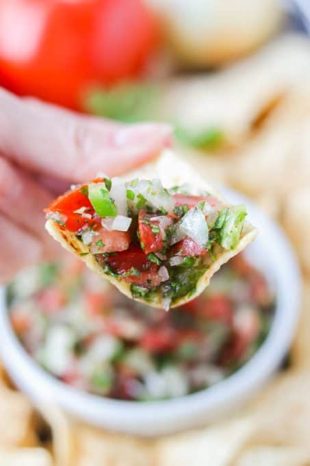 A tortilla chip filled with salsa fresca.