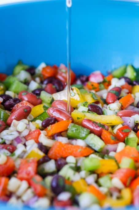 Pouring the marinade over the ingredients for Texas Caviar.