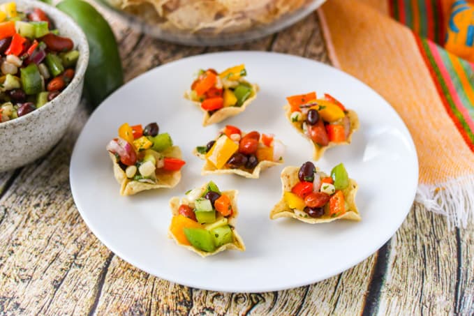 A plate full of tortilla scoops filled with an easy and delicious appetizer.