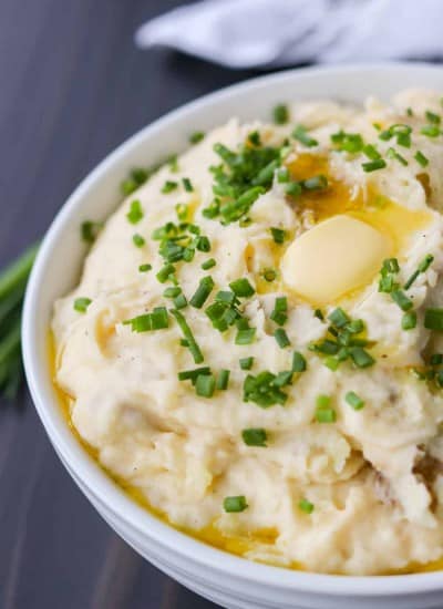 A bowl of the best mashed potatoes with cheese and chives