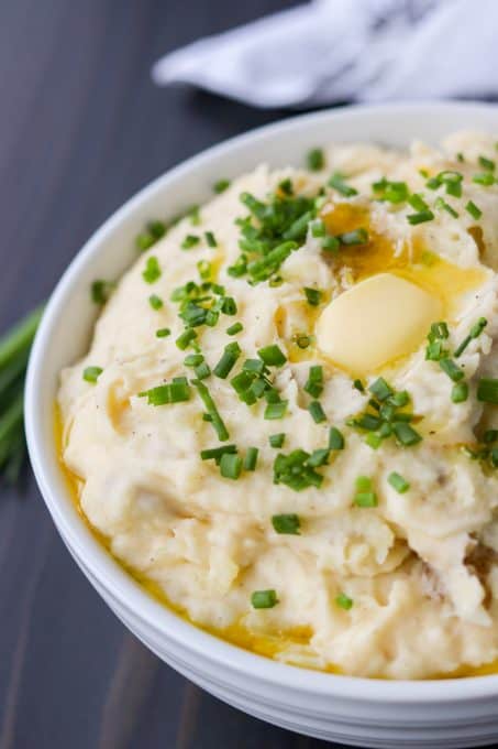 A bowl of the best mashed potatoes with cheese and chives