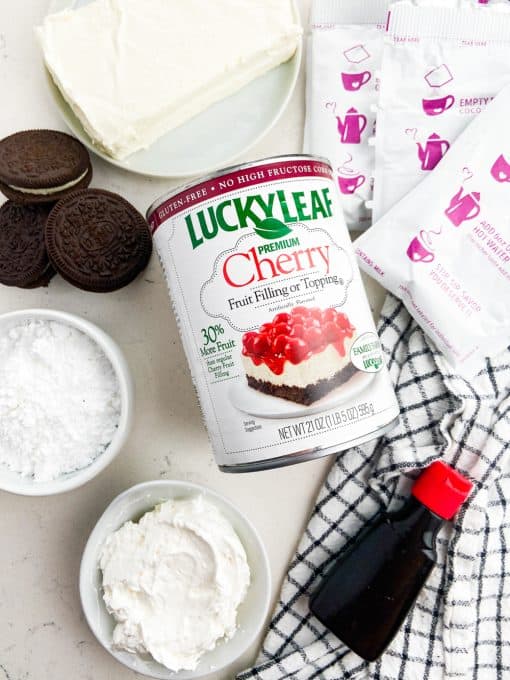 Ingredients for a chocolate cheesecake with cherry topping.