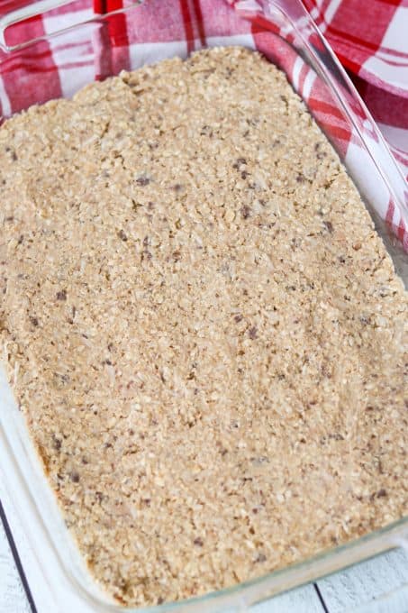 A pan of oatmeal bars with toffee and coconut ready for the oven.