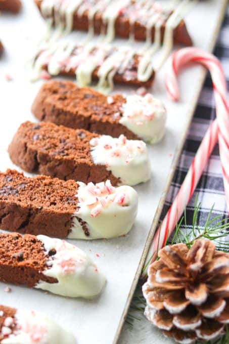 Chocolate biscotti dipped in white chocolate and sprinkled with crushed candy canes.