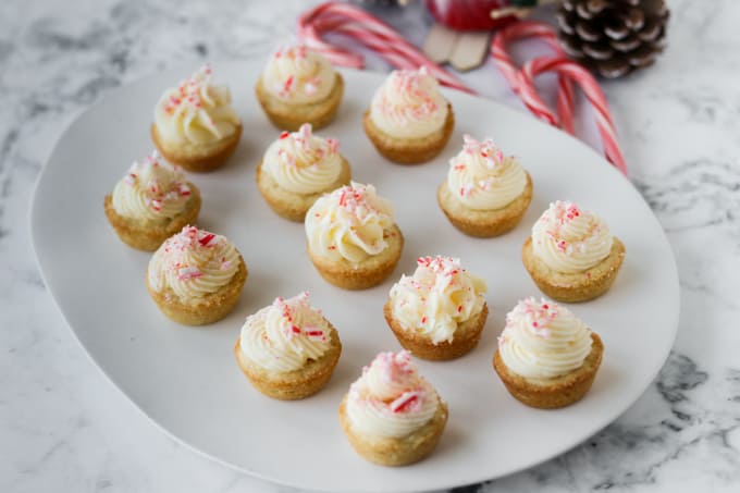 Buttercream frosting on top of cookie cups with crushed candy canes.