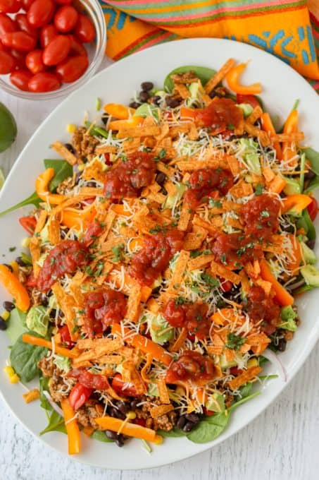 A taco salad with chicken, spinach, black beans and more.