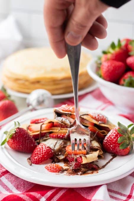 Taking a bite out of Strawberry Nutella Crepes.
