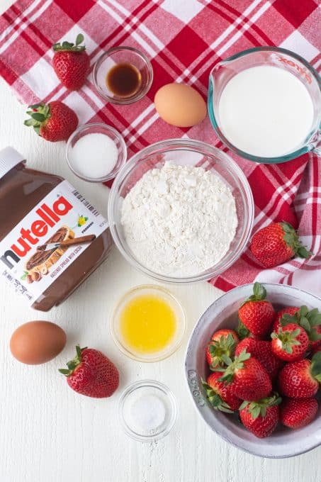 Ingredients for crepes filled with Nutella and strawberries.
