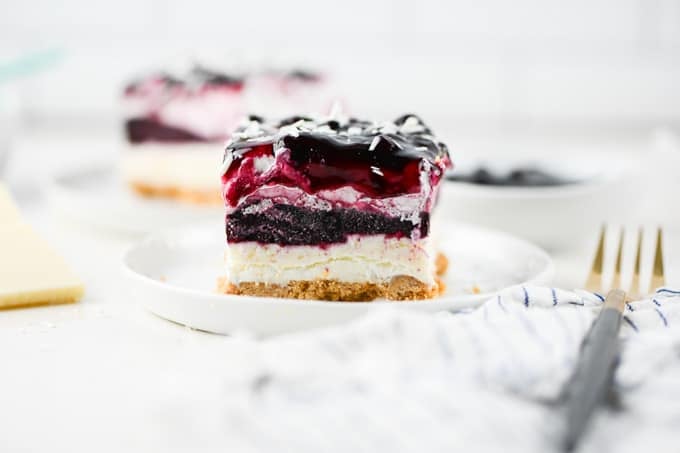 A cookie crust, almond cheesecake, blueberry fruit filling, and Cool Whip make up this easy no bake dessert.