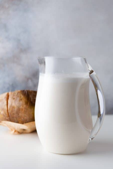 A pitcher of a drink made with coconut.