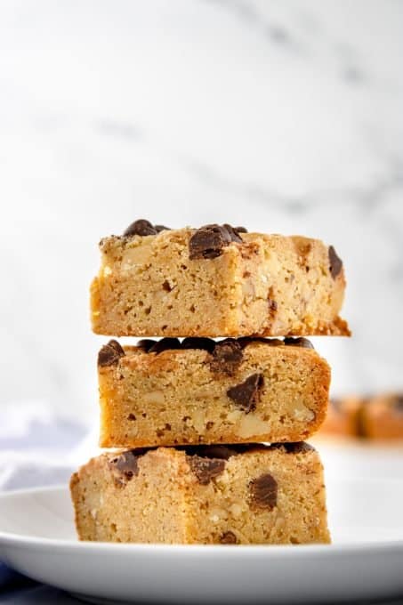 A stack of blondies with chocolate chips inside and on top.