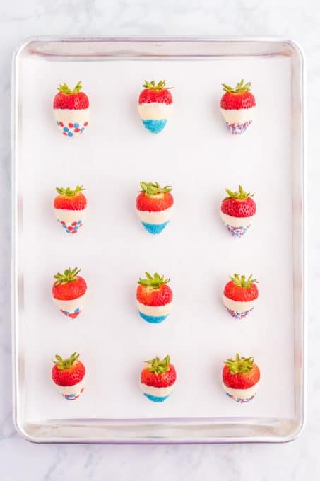 Strawberries dipped in white chocolate and dipped in red, white, and blue sprinkles.