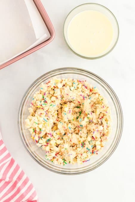 Adding sprinkles to the gooey bar dough