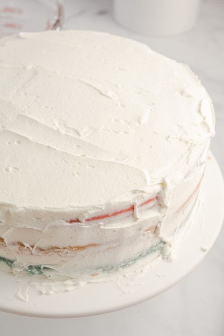 The crumb coat on a layer cake for a patriotic celebration.