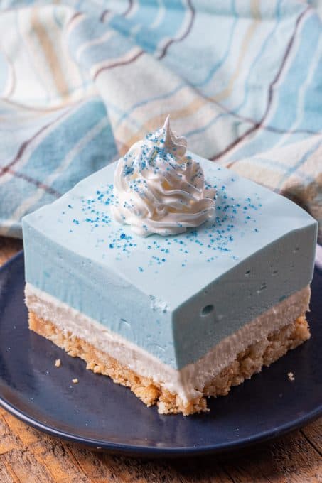 A layered cheesecake dessert with blue raspberry jello.