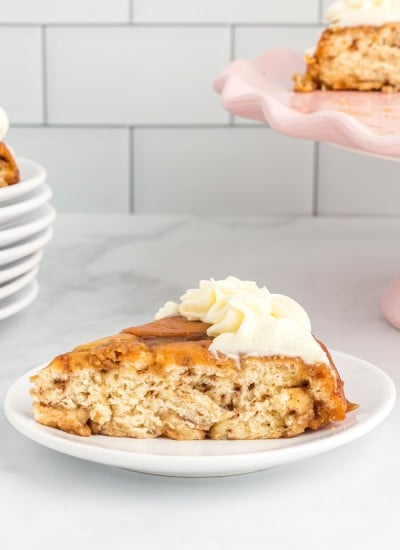 A cake slice made out of cinnamon rolls with cream cheese icing.