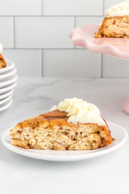 A cake slice made out of cinnamon rolls with cream cheese icing.