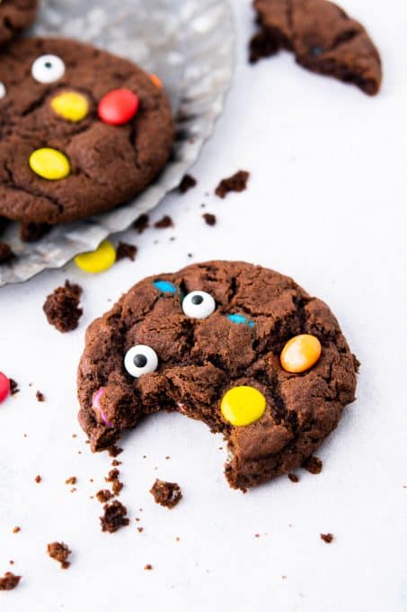 A bite taken out of a chocolate monster cookie.