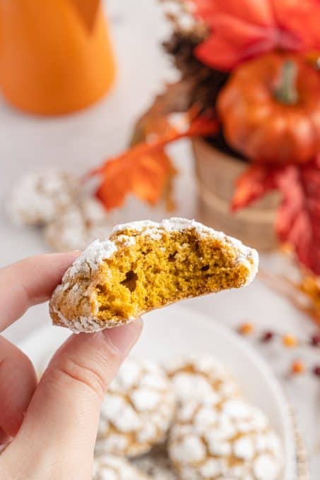 A bite taken out of a pumpkin crinkle cookie.