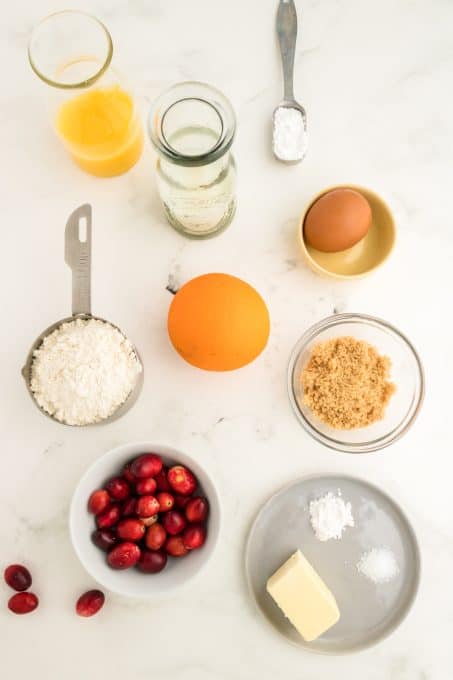 Ingredients for a quick bread flavored with orange and cranberries.