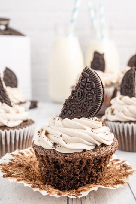 Unwrapping a chocolate cupcake made with Oreos