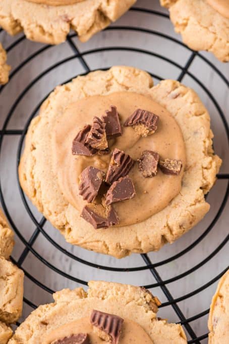 Chopped Reese's Peanut Butter Cups on a peanut butter frosted cookie.