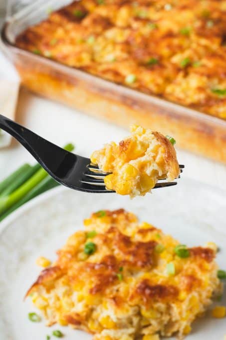 A forkful of corn pudding on a fork.