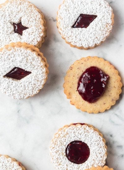 A bunch of Christmas cookies with raspberry jam.