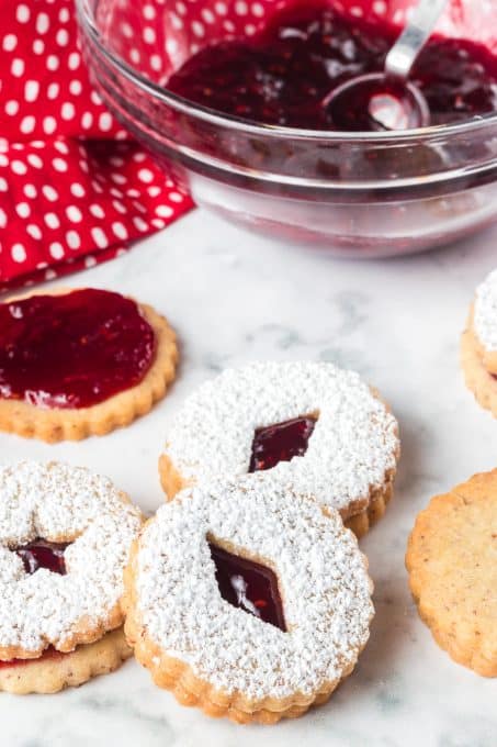 Cookies that are ready to be eaten with raspberry jam in the middle.