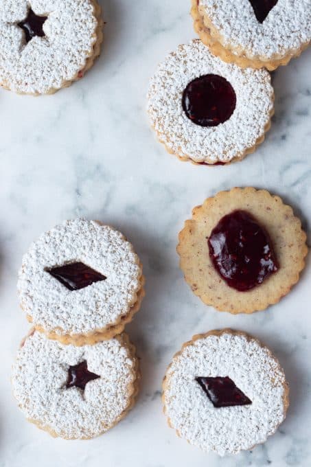 A bunch of Christmas cookies with raspberry jam.