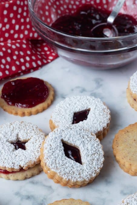 Cookies that are ready to be eaten with raspberry jam in the middle.