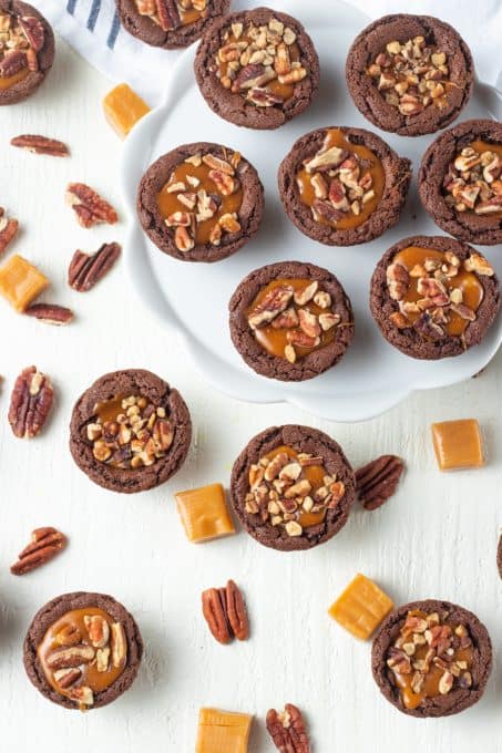 Pecans on caramel in a cookie cup.