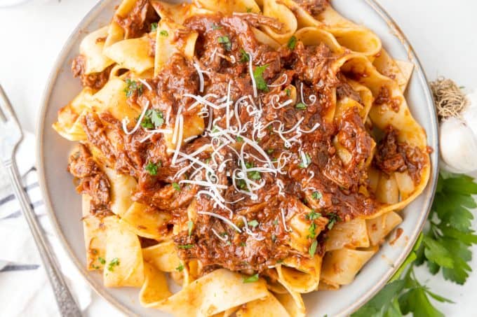 A plate of noodles and beef sauce.