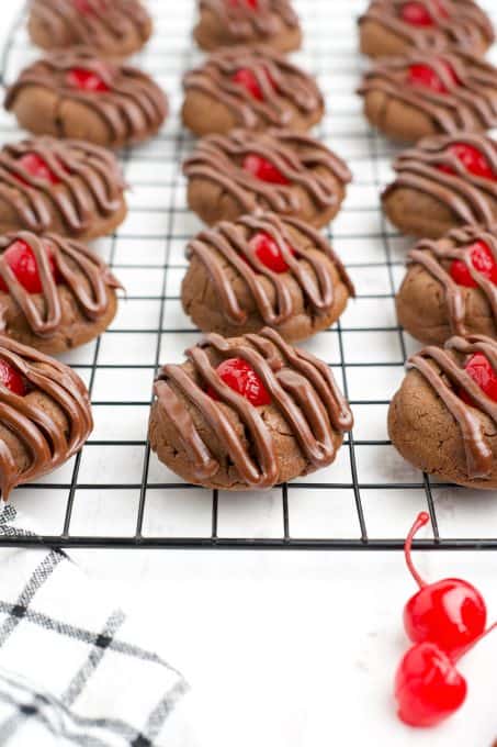 Chocolate piped onto chocolate cookies.