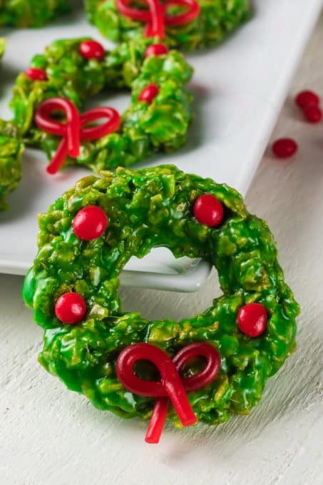Cinnamon candies and bows on green wreath cookies.