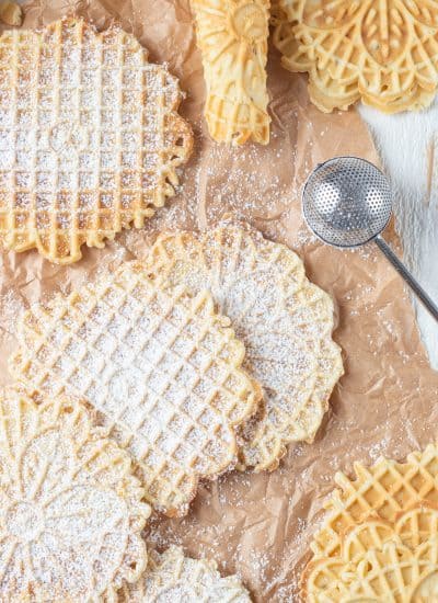 Pizzelles dusted with powdered sugar.