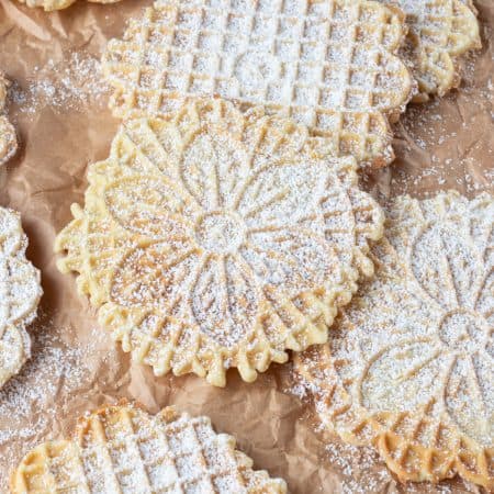 Italian waffle cookies dusted with powdered sugar.