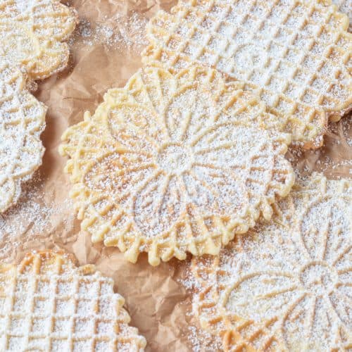 Italian waffle cookies dusted with powdered sugar.