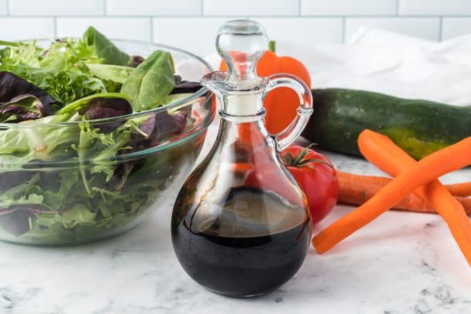 A cruet filled with a balsamic reduction.