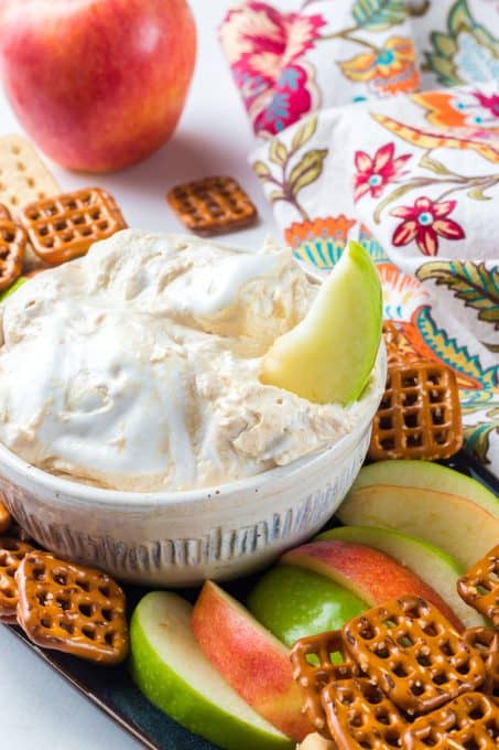 An apple slice in marshmallow dip.