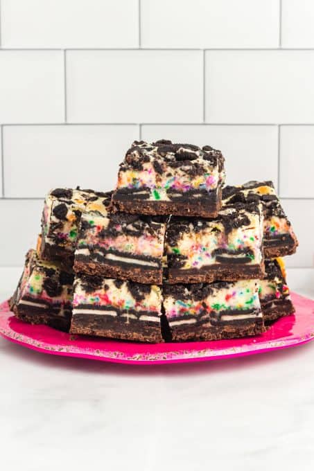 A pate full of Oreo Cheesecake Bars with sprinkles.