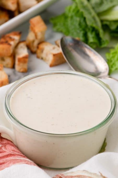 A bowl of dressing for Caesar salad.