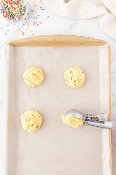 Putting cookie dough onto a baking sheet.