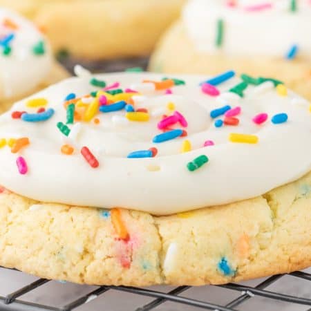 A Birthday cake cookie with lots of sprinkles.