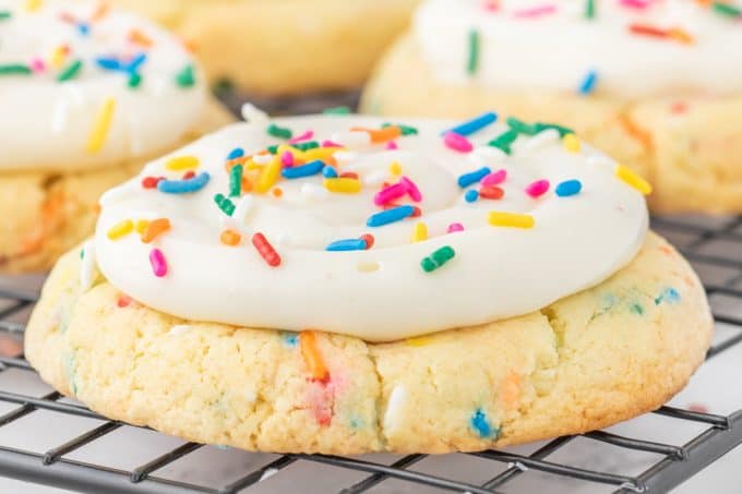 A Birthday cake cookie with lots of sprinkles.