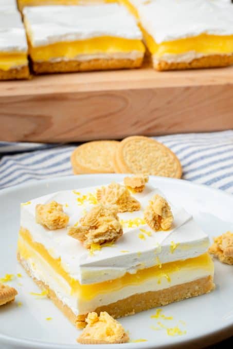 A lemon cookie crust, cheesecake, lemon curd and Cool Whip make them Lemon Bars.