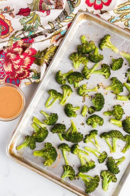 Cooked broccoli and a peanut sauce for drizzling.