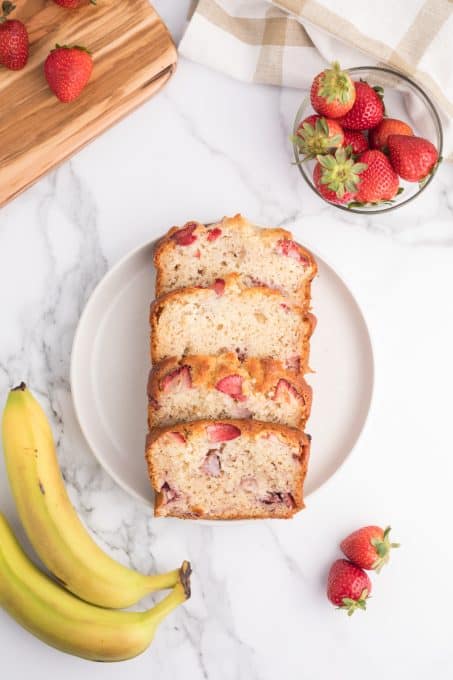 Slices of a banana quick bread with strawberries